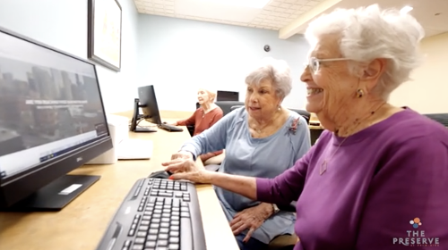 two elderly women looking at computer 